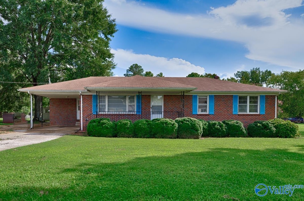 Featuring covered front porch and attached one car carport.