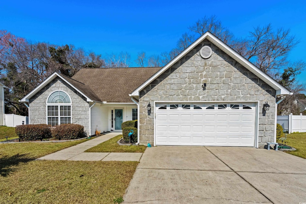 Single story home with a front yard, fence, stone 