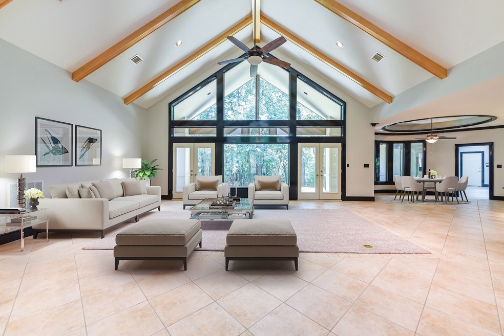 From the moment you enter the front doors, you will see  just how unique this house is. No attention to detail has been left out in this uniquely custom built home. This family room has amazing windows that you just need to see in person, the 21
