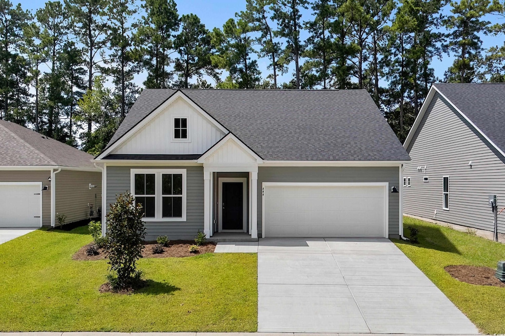 Front of home featuring a 4 car driveway, 2 car garage, and board and batten siding.