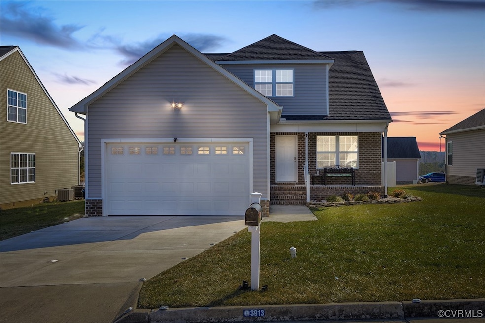 View of front of property with a garage and a yard