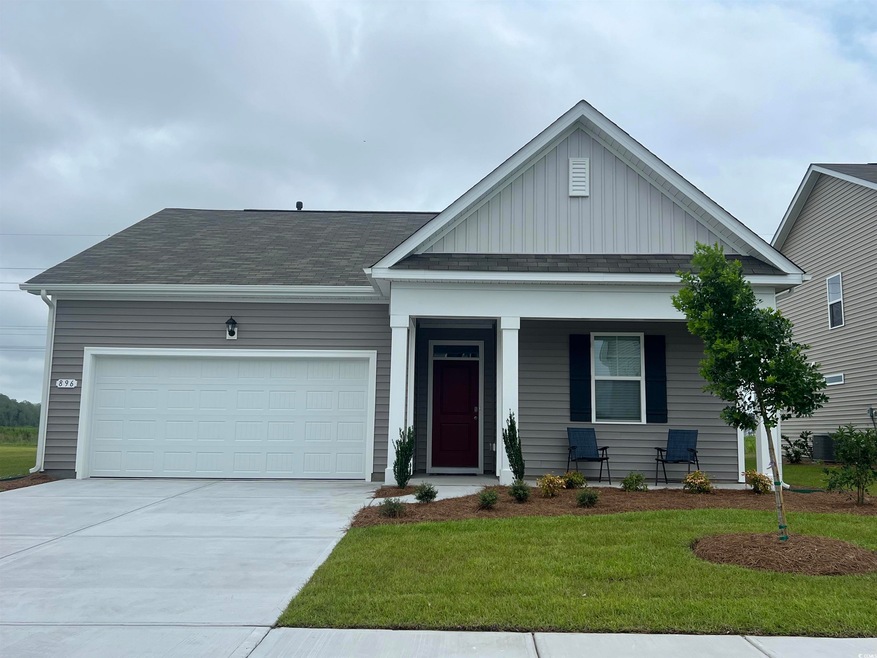 View of front of home featuring a garage, covered 