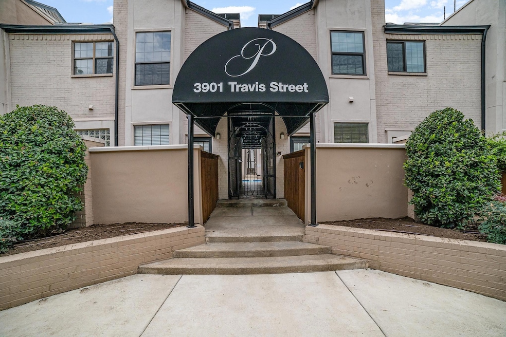 View of exterior entry with stucco siding, a gate,