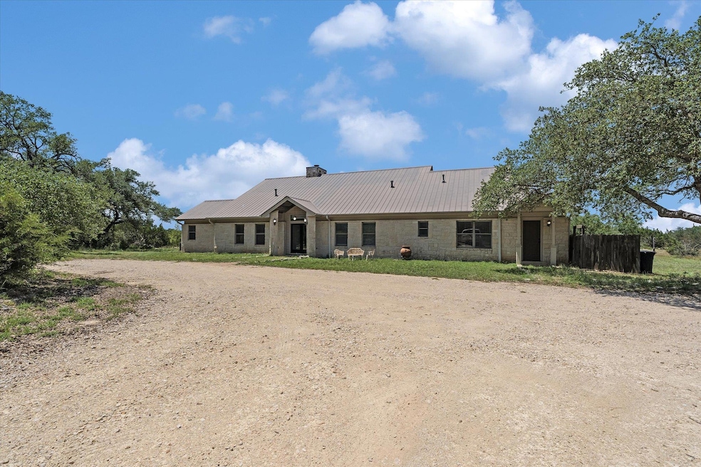 View of front facade featuring dirt driveway, a c
