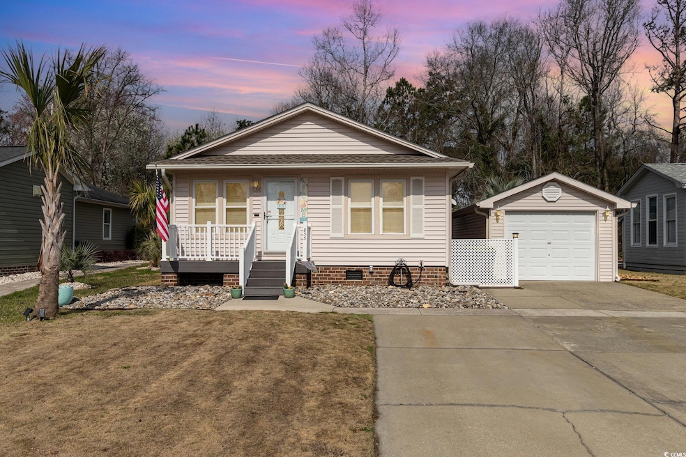 Bungalow with a lawn, covered porch, an outdoor st