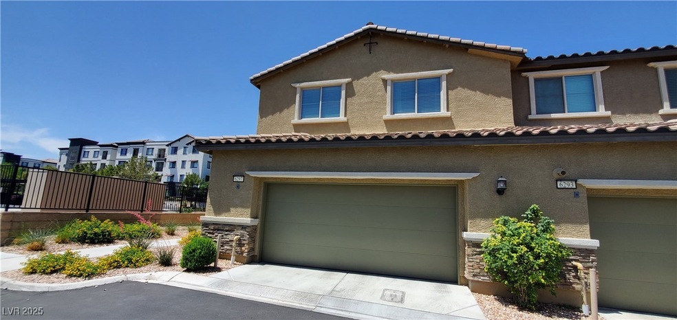 View of front of property featuring a garage, stuc