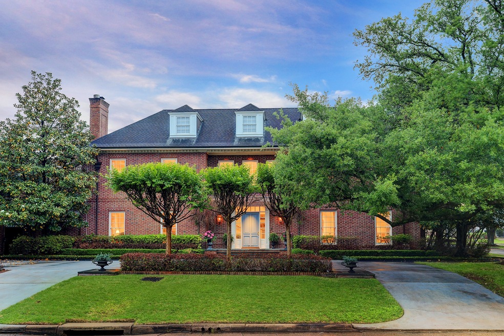 Lovely landscaping, a circular drive, classic bric