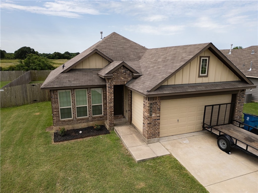 View of front of home with brick siding, board and
