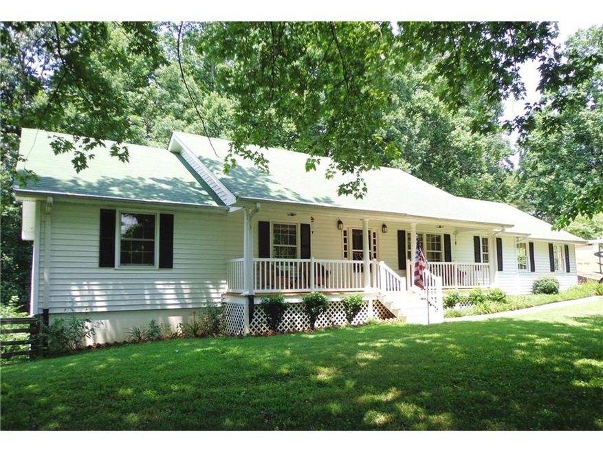 Enjoy rocking chair front porch shaded by numerous