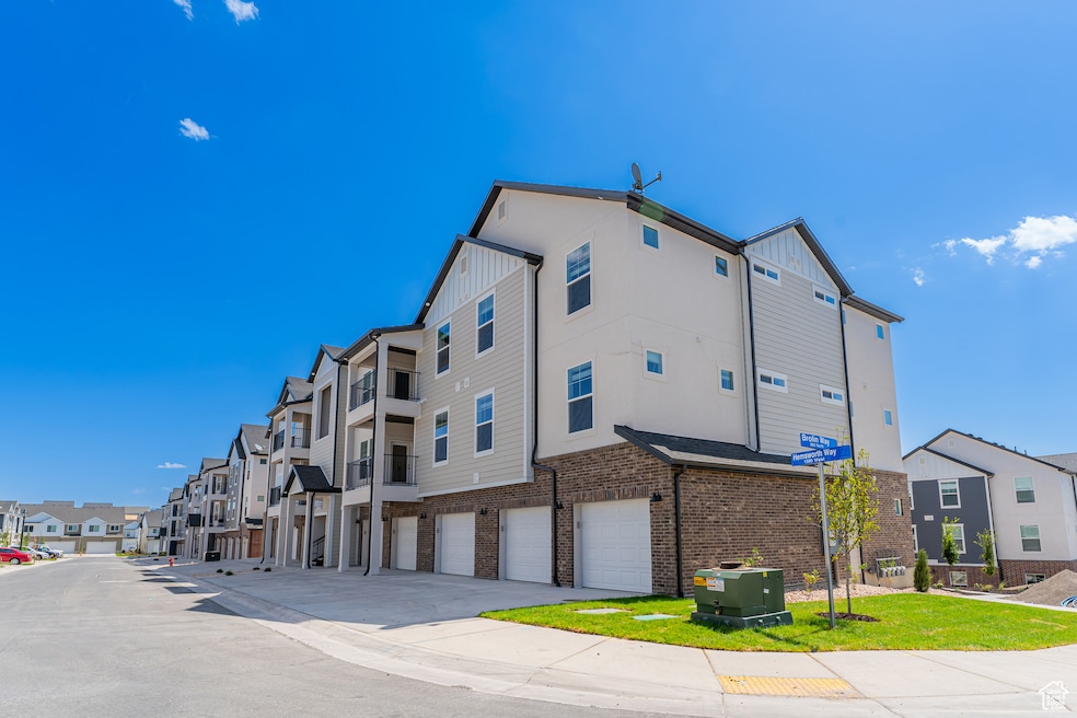 View of property featuring a residential view, driveway, and a garage