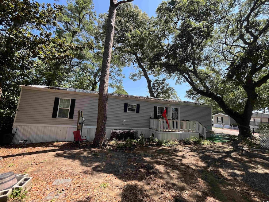 View of front of house featuring a wooden deck