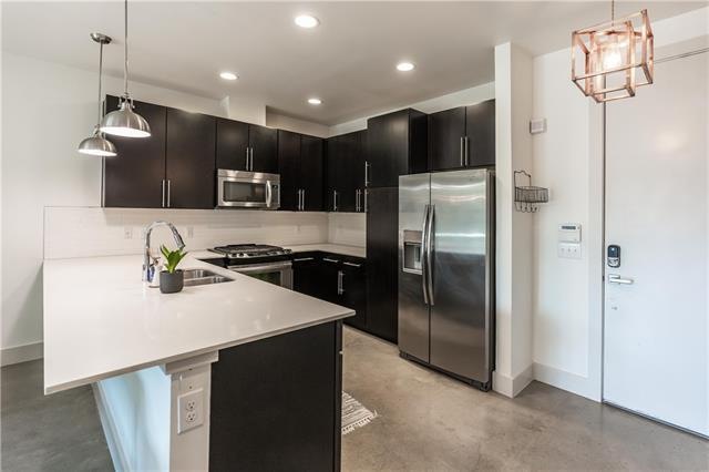 Beautiful large open kitchen with white quarts cou