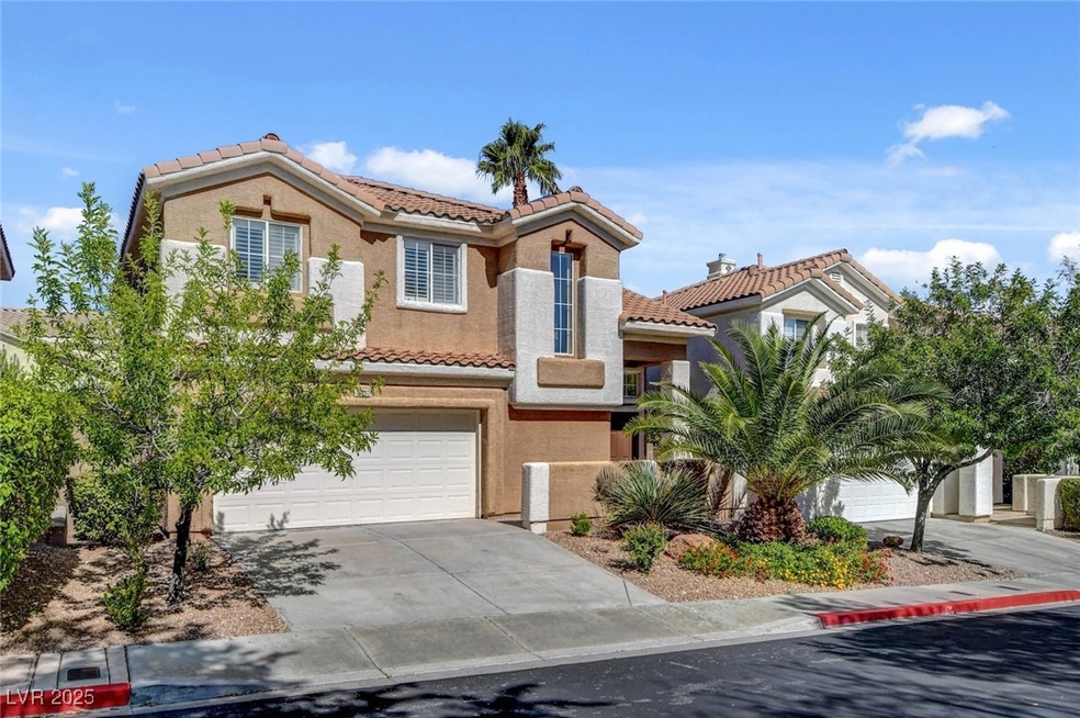 Mediterranean / spanish home featuring a tile roof, stucco siding, concrete driveway, and a garage