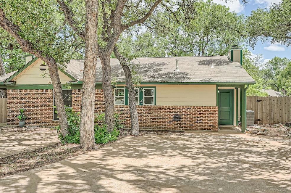 View of front of home with brick siding, a chimne