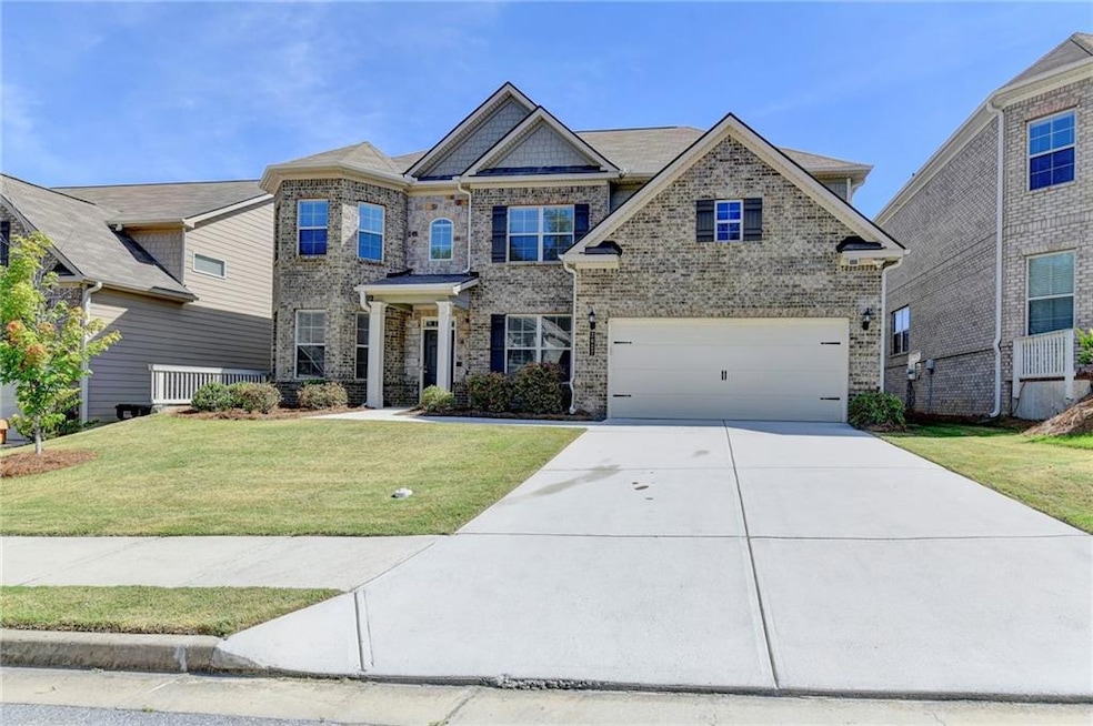 Craftsman-style home with a front yard and a garag