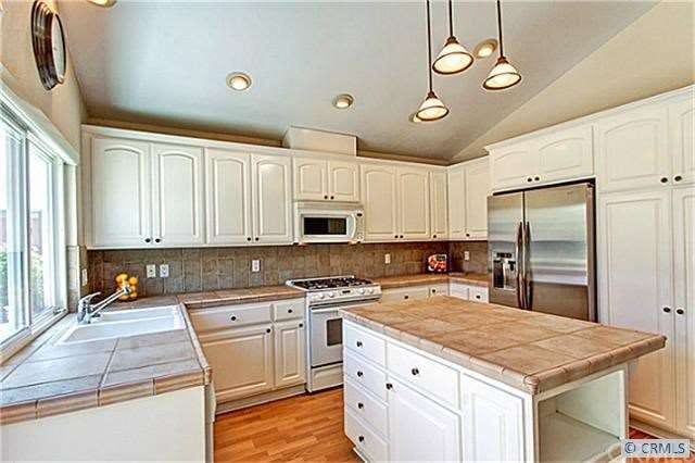 Light-filled open kitchen.  Pantry has pull-out sh