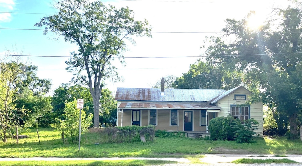 The welcoming covered porch, tall windows, and a s