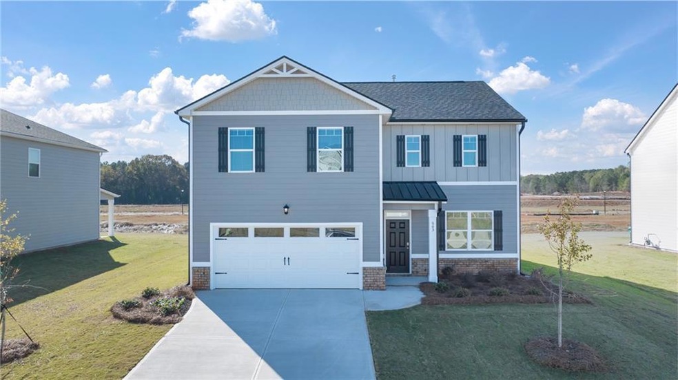 Craftsman-style house with a garage and a front ya