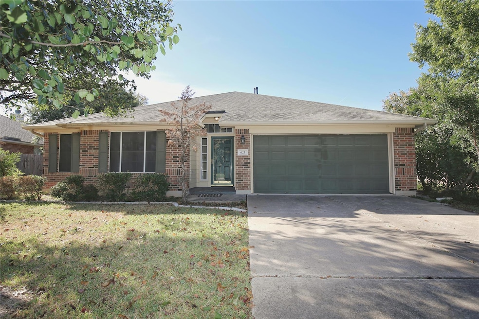 Single story home with brick siding, concrete driveway, a front lawn, a shingled roof, and a garage