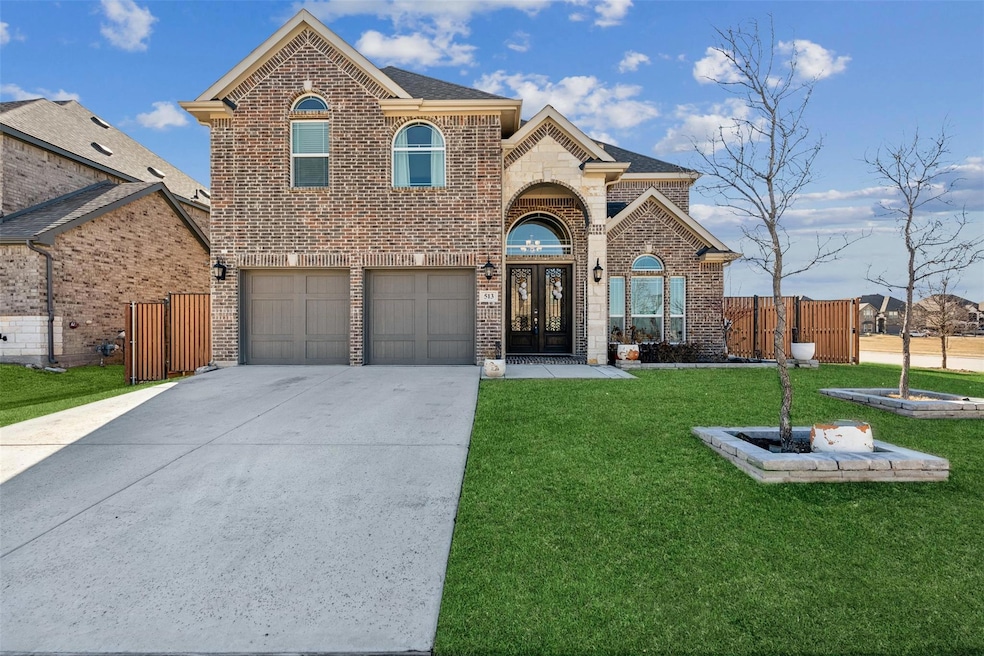 Front facade featuring a garage, a front lawn, and