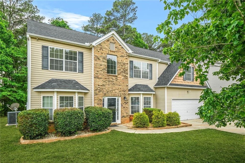 Colonial-style house featuring an attached garage,