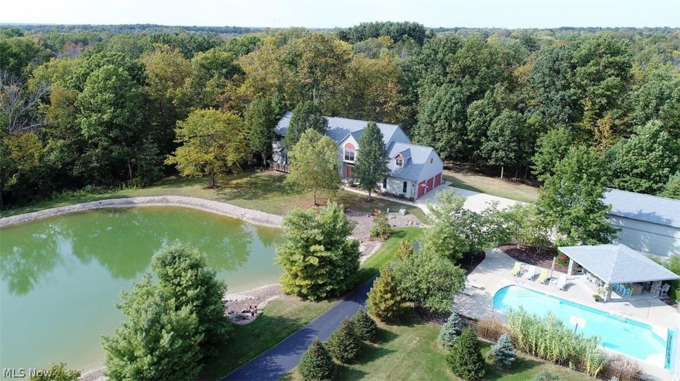 This 9.5 acre estate property offers vacation style living. Enjoy the lake, a resort style pool I=with a cabana and bar.