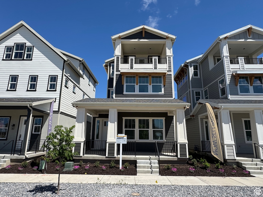 View of front of property with covered porch and a shingled roof