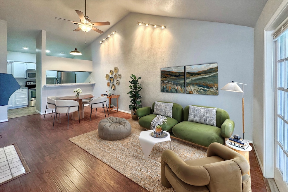 Living and dining area with vaulted ceiling