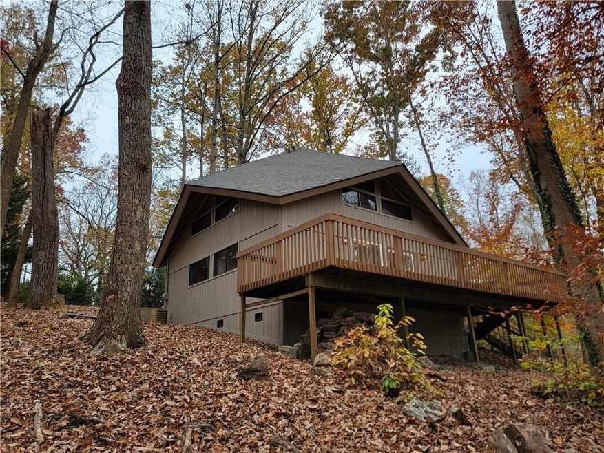 Rear view of house featuring a wooden deck