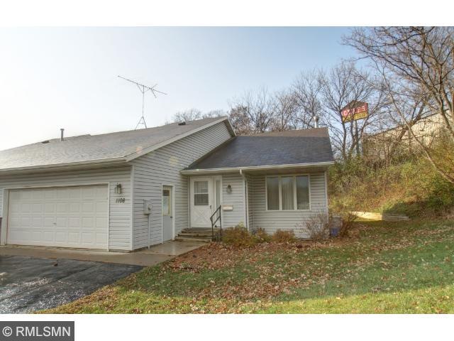 Twin home has vinyl siding and only one other unit