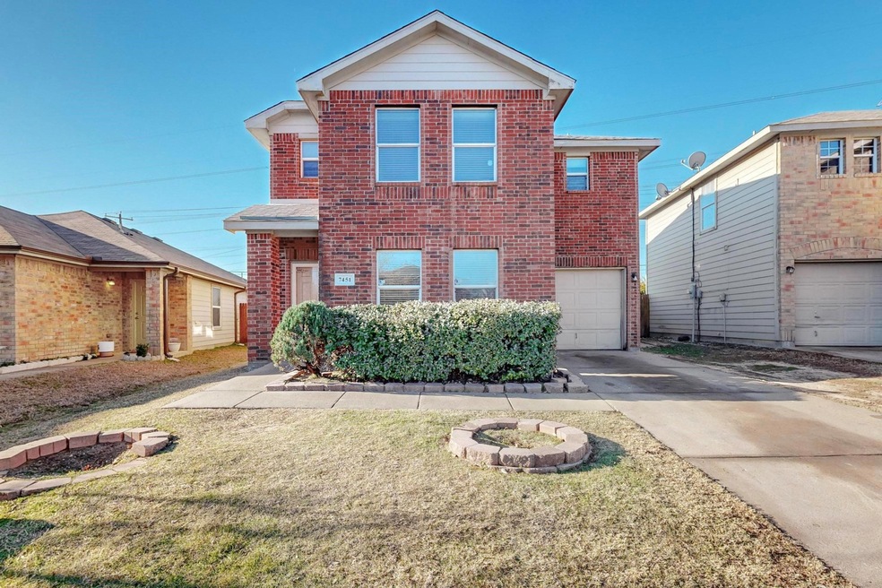 Front of property with a garage and a front yard