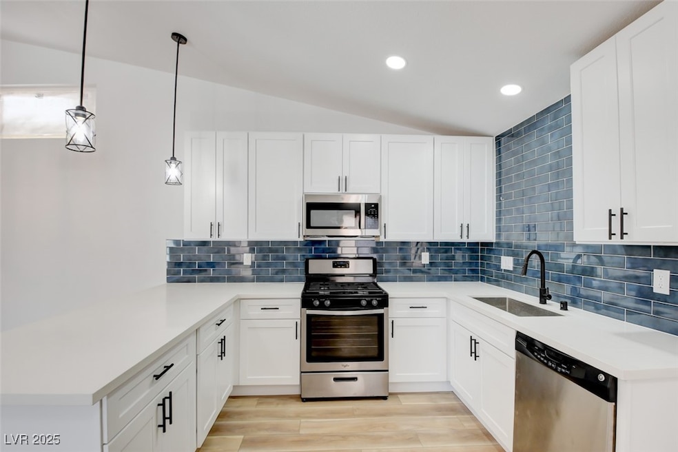 Kitchen with stainless steel appliances, a peninsu