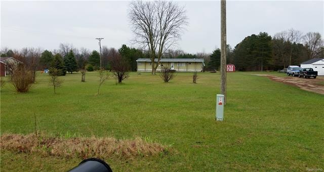 View of Land + Mobile Home from Street.