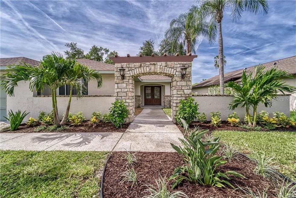 JUST ONE LOOK AND YOU WILL FALL IN LOVE! UNIQUE STONE ARCHWAY FRAMES THE OVERALL BEAUTY OF THIS HOME WITH LUSH NEW TROPICAL LANDSCAPING AND SOD SETS IT APART FROM ALL OTHERS!