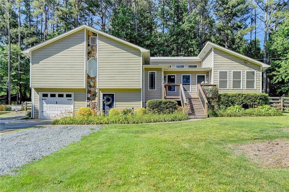 View of front of house with a garage and a front l