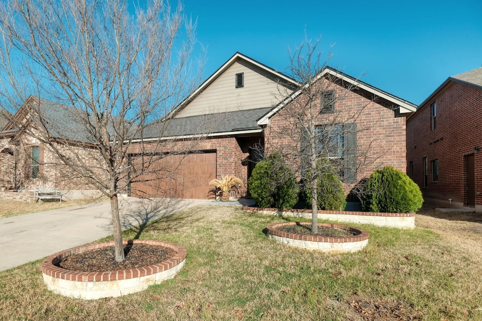 Single story home with driveway, an attached gara
