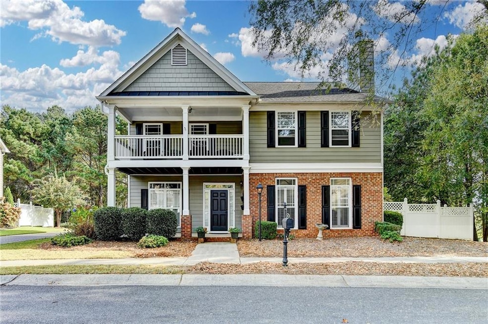 Craftsman-style home featuring covered porch, brick siding, and a chimney