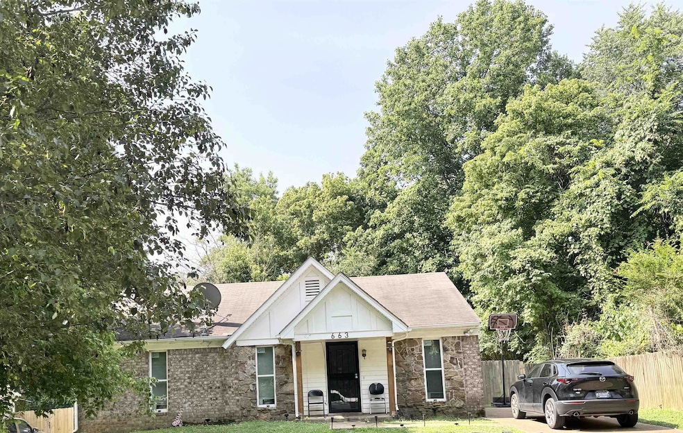 View of front facade with board and batten siding, stone siding, roof with shingles, and a porch