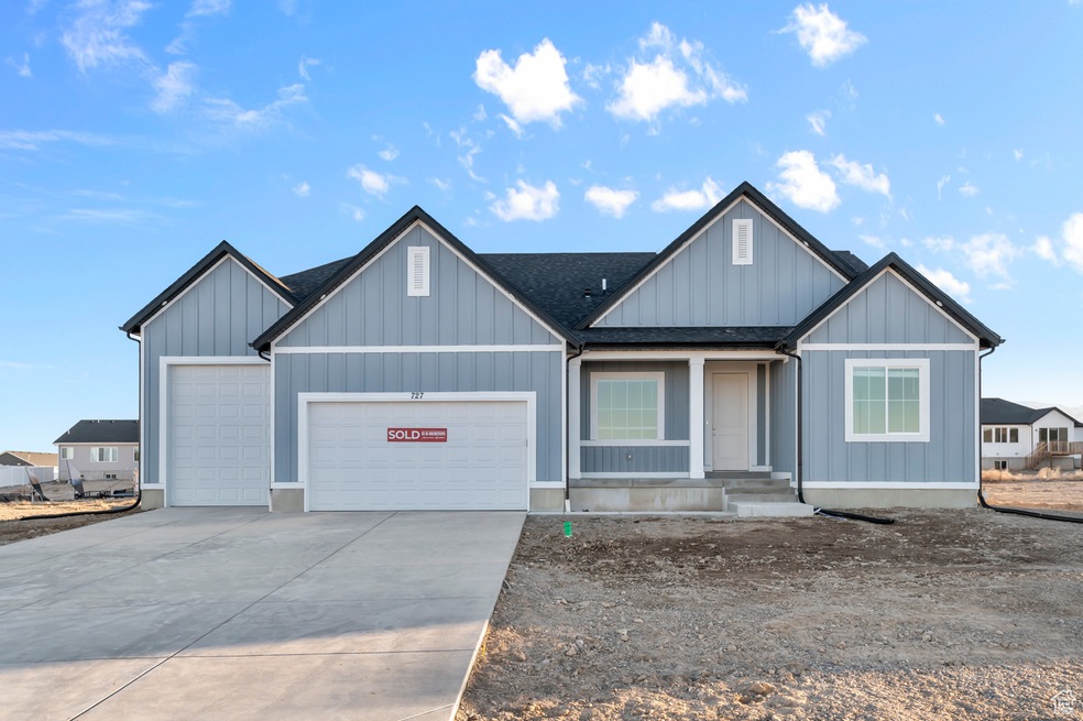 View of front facade featuring a garage, covered porch, concrete driveway, board and batten siding, and roof with shingles