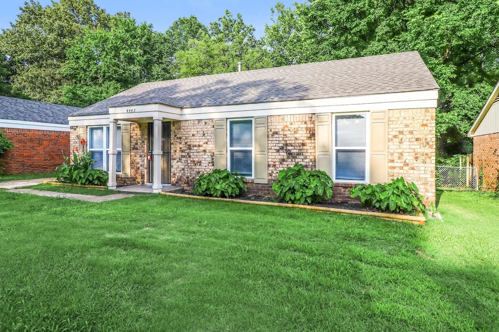 Ranch-style house with roof with shingles and brick siding