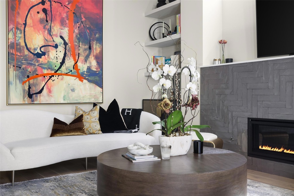 Living area featuring a glass covered fireplace a