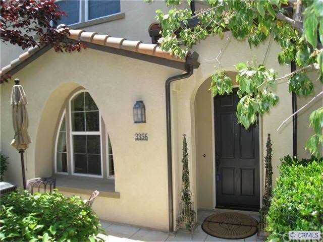Front entry through path of green trees and shrubs