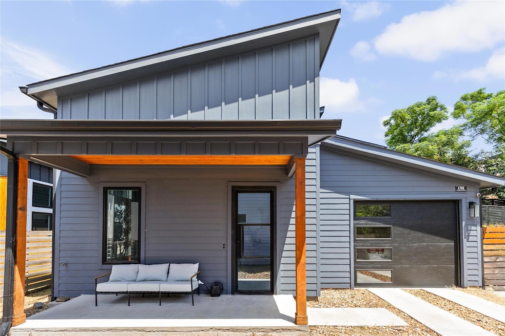 Rear view of house with board and batten siding and a garage