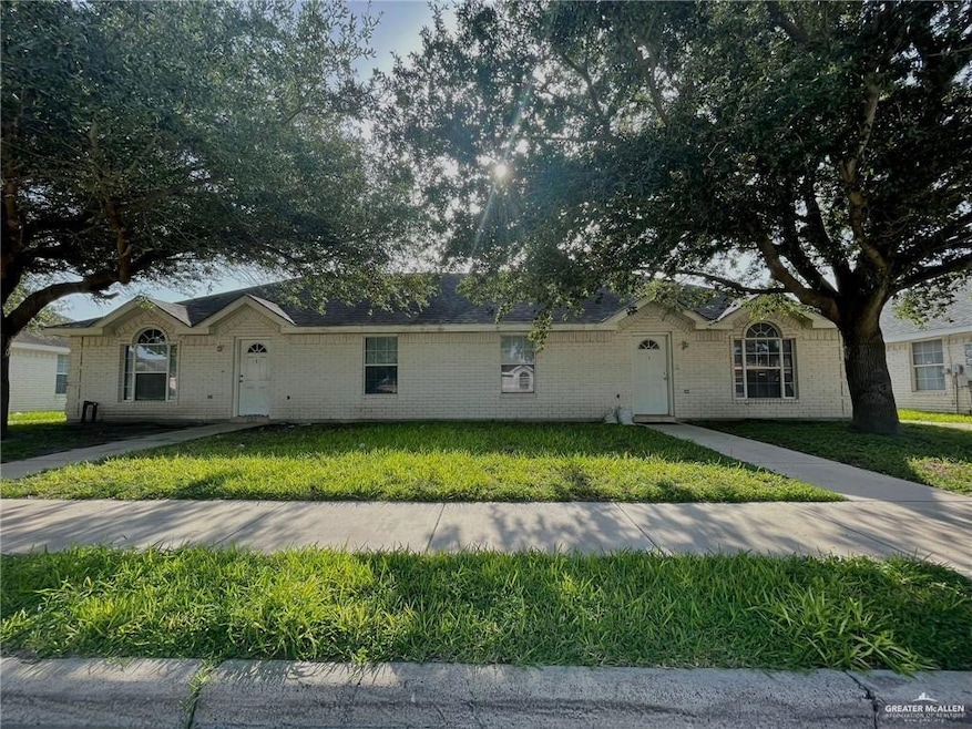 Single story home featuring a front lawn and brick siding