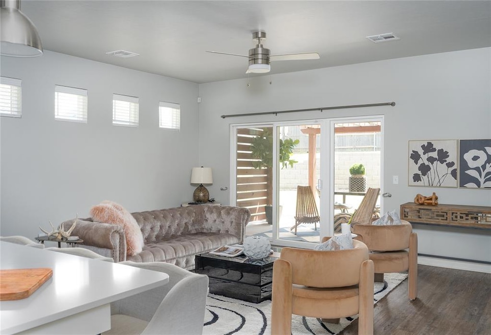 Living area with a ceiling fan and wood finished floors