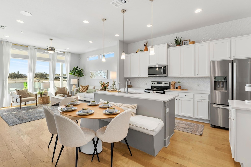 Kitchen featuring light countertops, stainless st