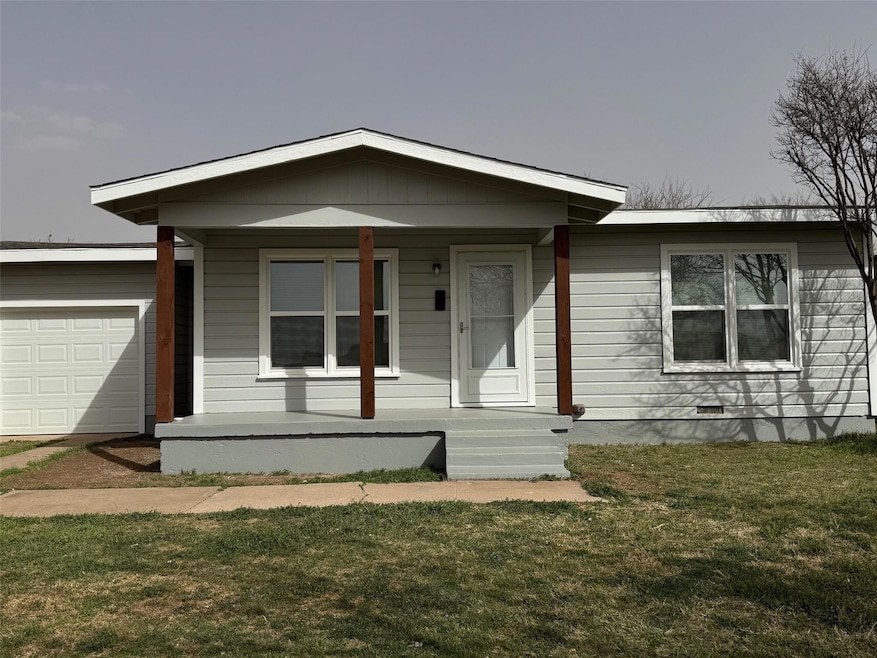 View of front facade with a front lawn, an attache