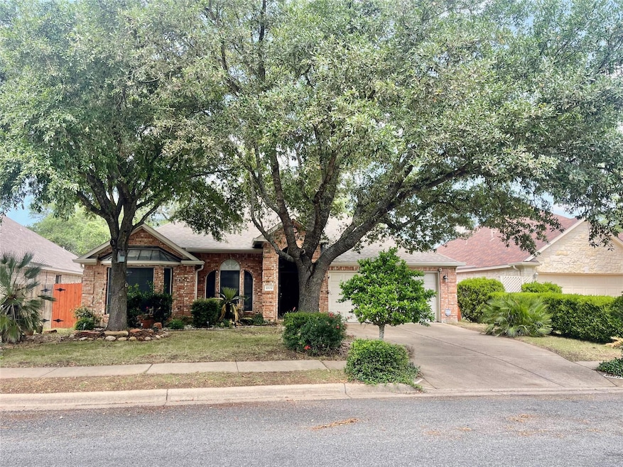Single story home featuring driveway, a garage, f