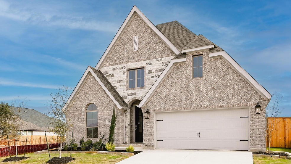 View of front of home with brick siding, concrete