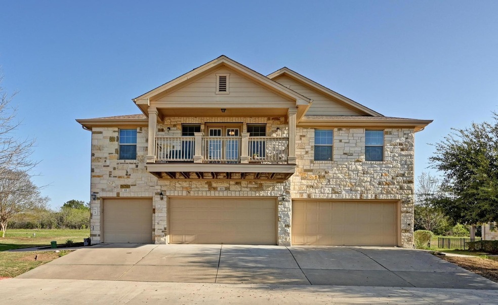 View of front of property featuring a balcony, an